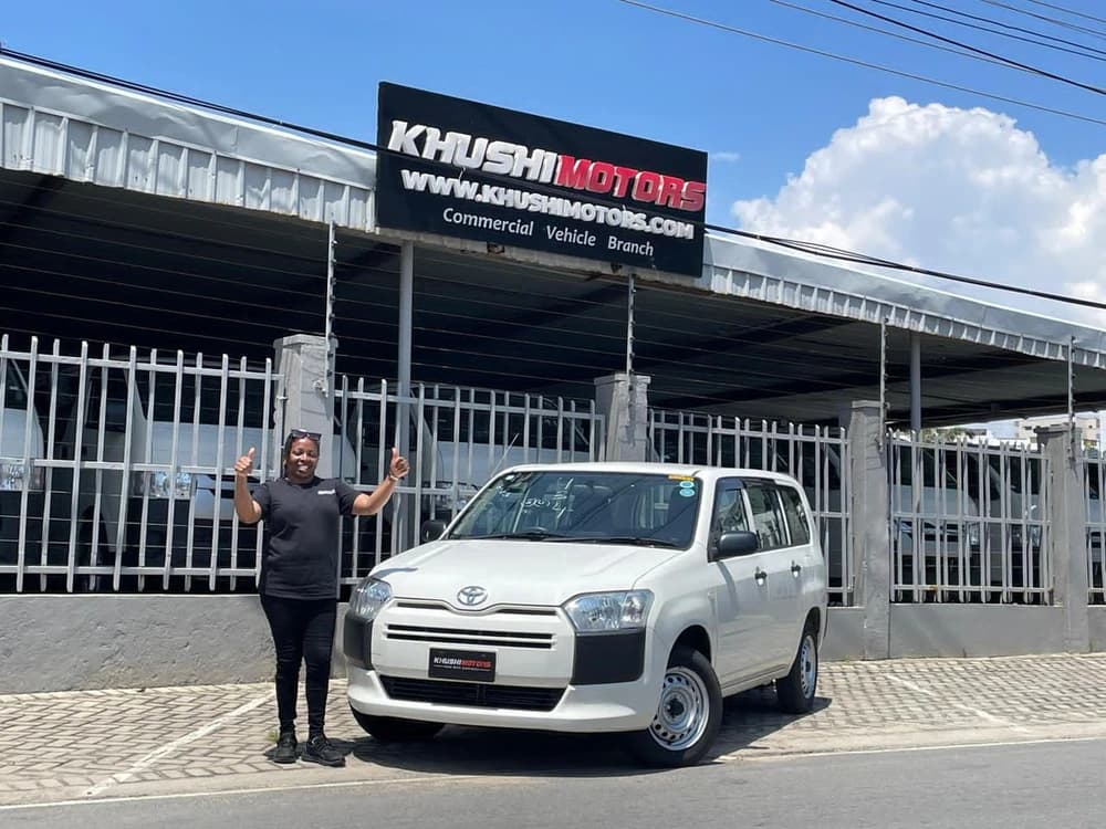 Proud customer with newly purchased car in Kenya