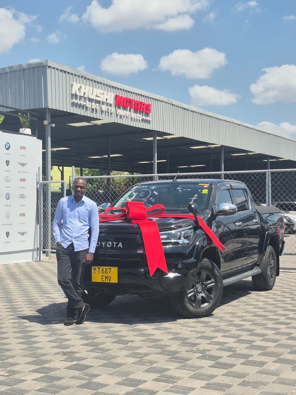 Happy customer with newly delivered car in Dar es Salaam